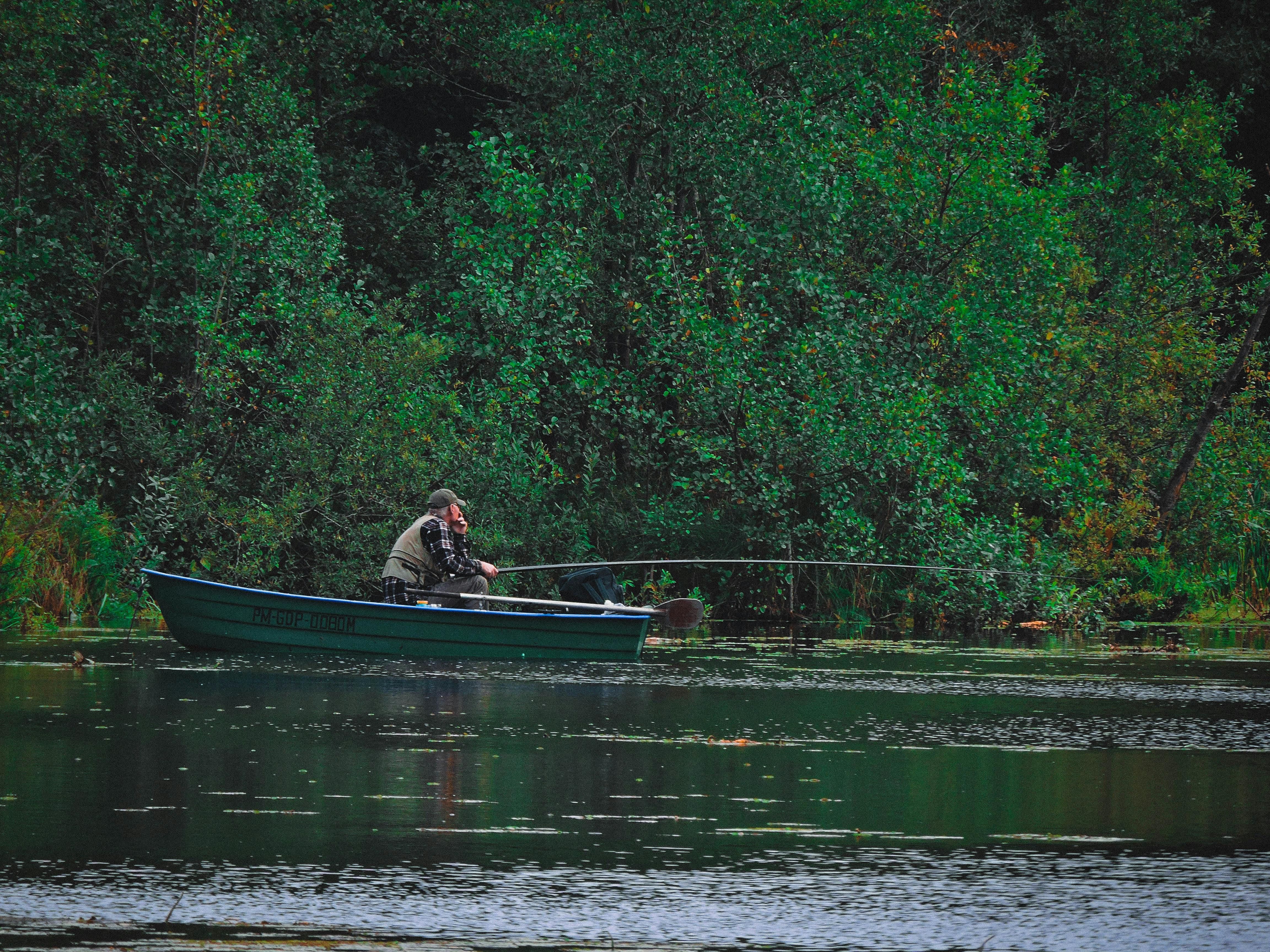 Fish the pond of Otisco Lake Man fishing on small boat